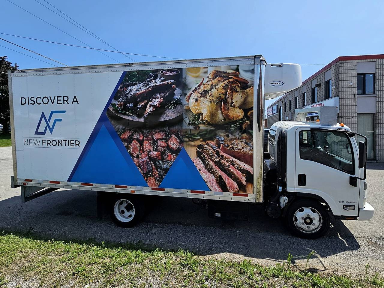 New Frontier refrigerated delivery truck with the company's branded wrap